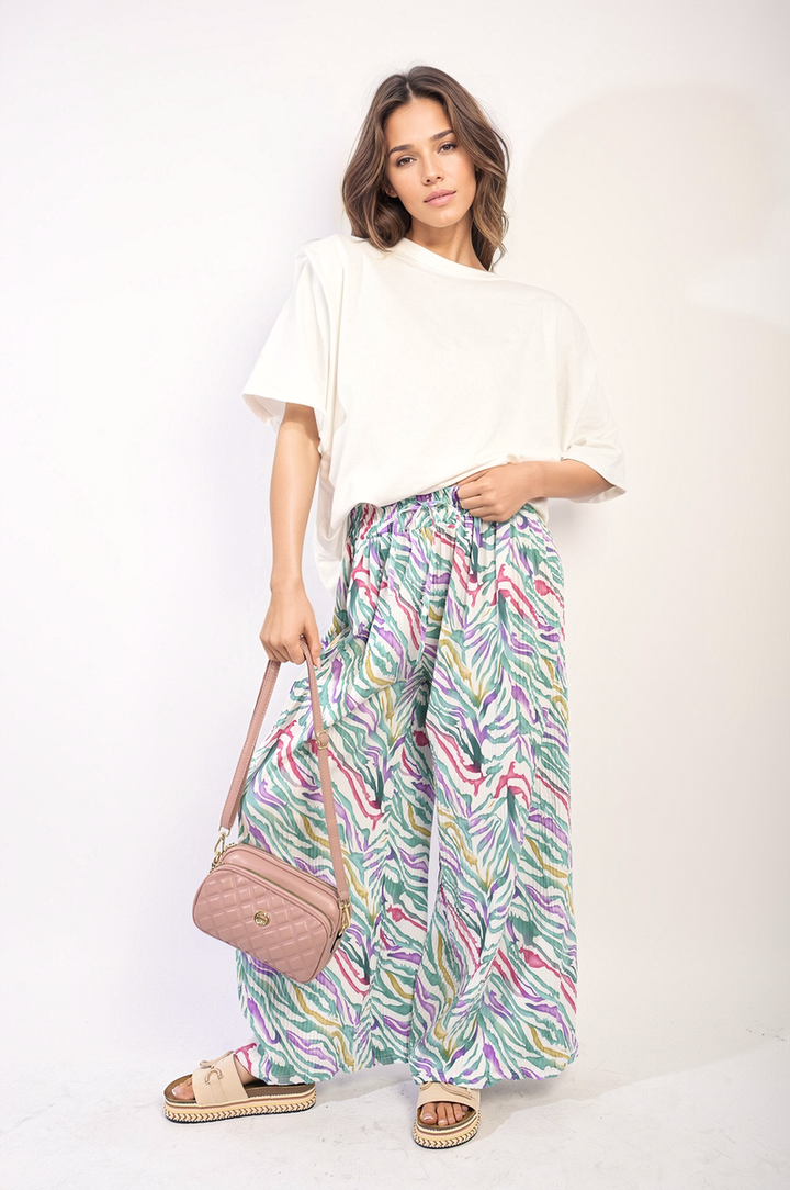 Woman holding Pleated Wide Leg and Elastic Waist Trousers, showcasing their elegant design and comfort, perfect for both casual and formal occasions.