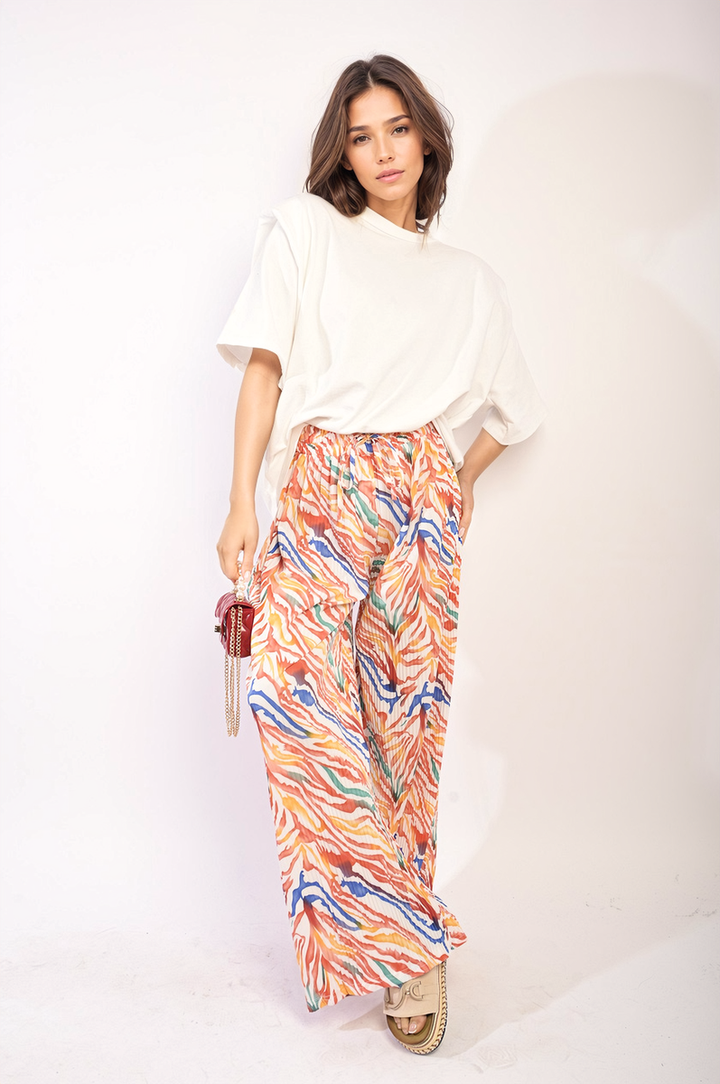 Woman modeling Pleated Wide Leg and Elastic Waist Trousers, showcasing their elegant, wide-leg design and comfortable fit, ideal for casual or formal occasions.