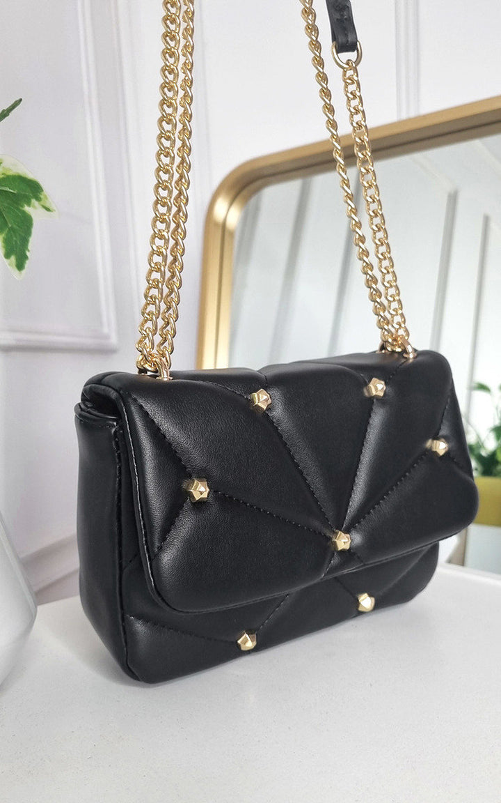 Studded with Chain Detail Handbag featuring gold chains and studs, perfect for adding luxury to your style.