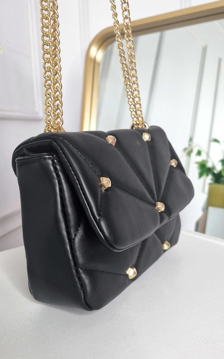 Studded with Chain Detail Handbag featuring black faux leather with gold chains and studs, ideal for adding luxury to your style.