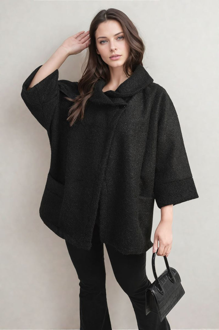 Woman wearing Elle Cowl Neck Oversized Cape Jacket, showcasing its cozy cowl neck and trendy cape style, perfect for casual outings and chilly days.