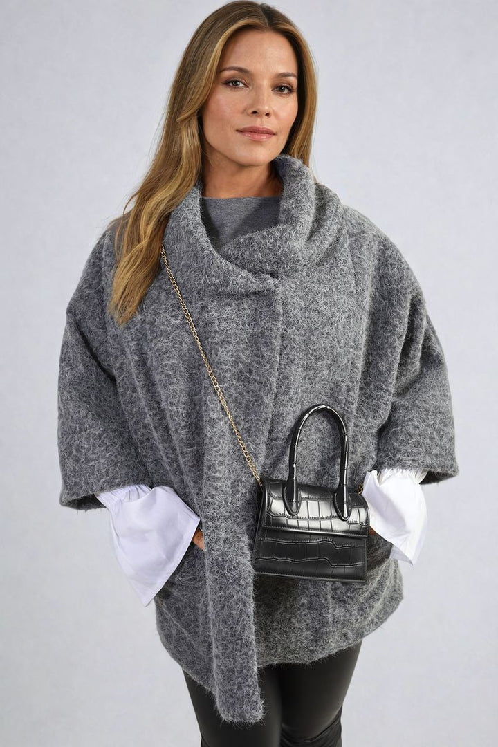 Woman wearing the Elle Cowl Neck Oversized Cape Jacket, showcasing its cozy cowl neck and trendy oversized fit, perfect for stylish layering.