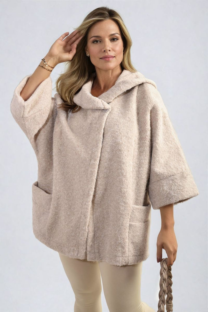 Woman wearing a Cowl Neck Oversized Cape Jacket with a cozy cowl neck and loose fit, showcasing a stylish layering option for casual outings.