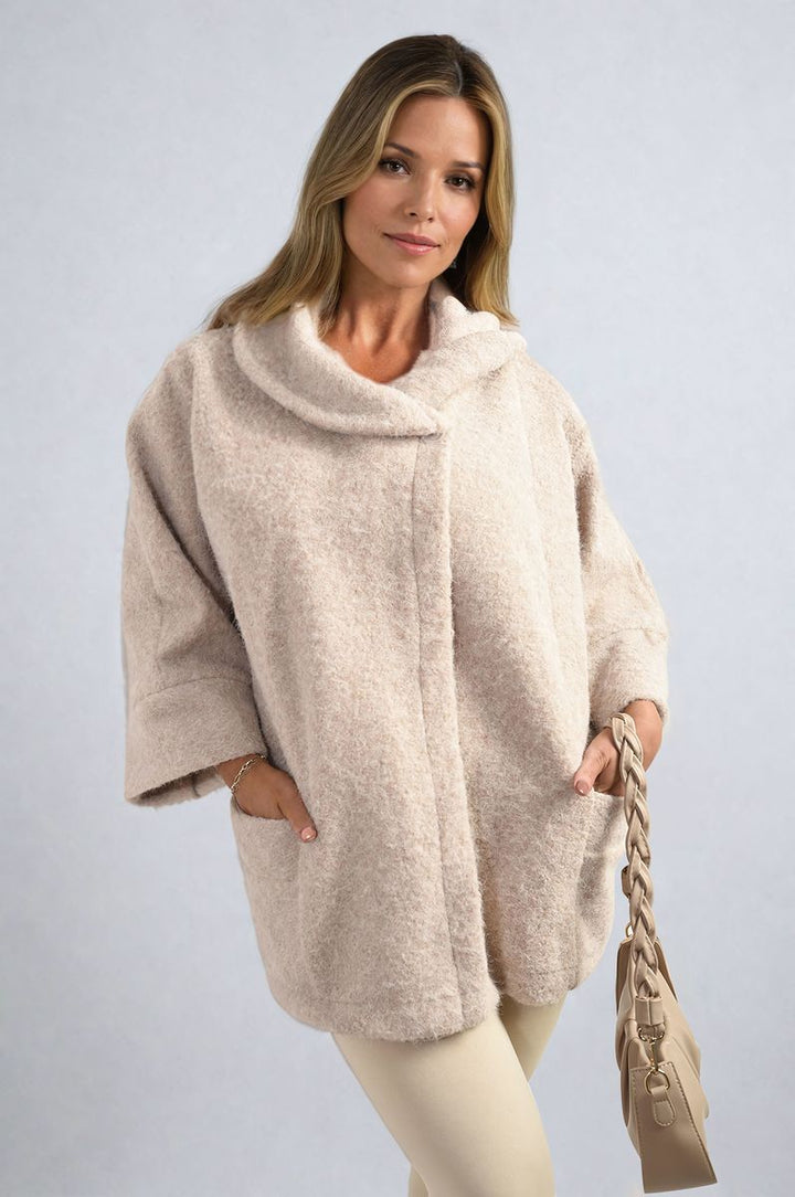 Woman wearing the Elle Cowl Neck Oversized Cape Jacket, showcasing its cozy cowl neck and oversized fit, ideal for stylish layering and casual outings.