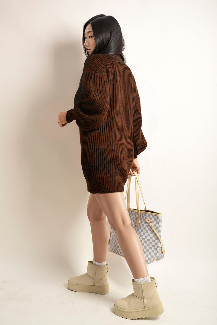 Woman wearing Chunky High Neck Knitted Jumper, paired with tan boots, highlighting cozy and stylish design from Holiday Clothes UK.