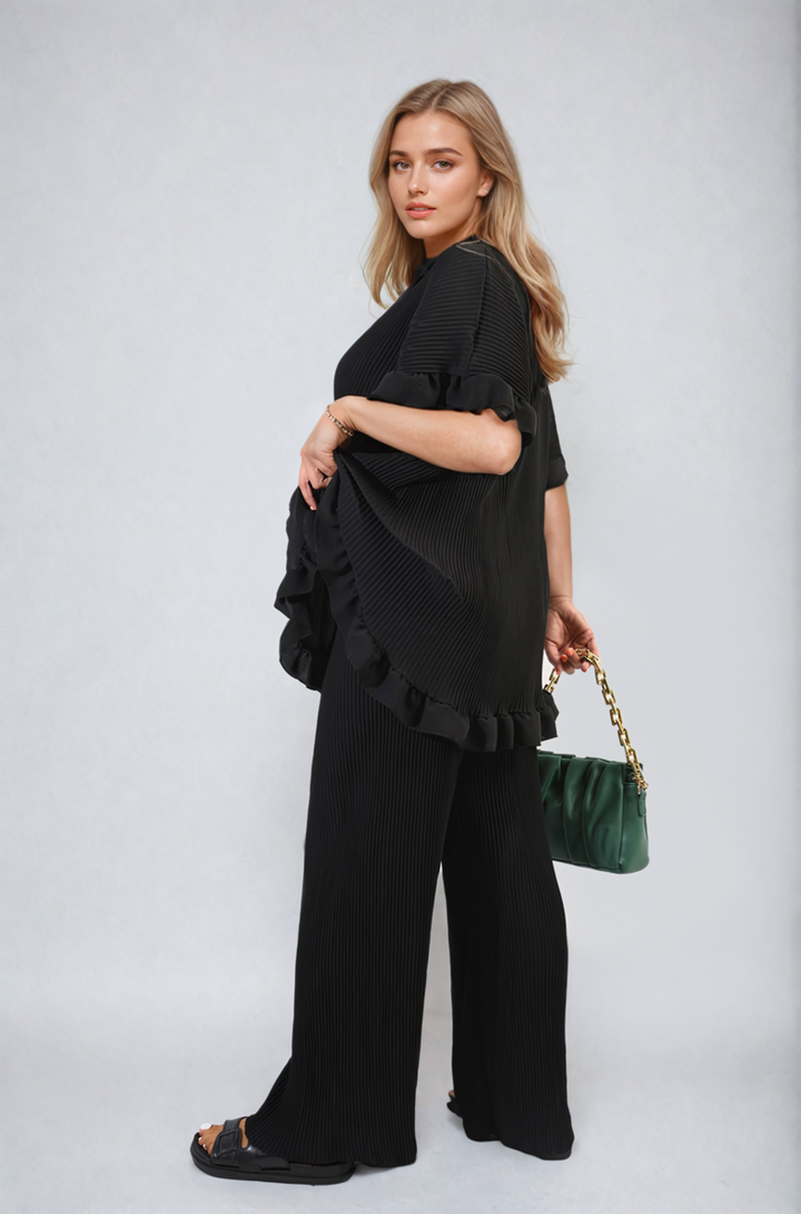 Woman wearing the Emily Button Pleated Frill Ruffle Top and Wide Leg Trouser Co-ord Set, showcasing its elegant design and flattering silhouette.