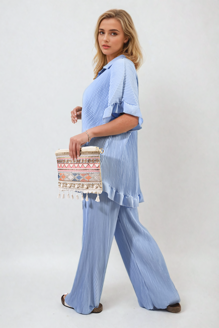 Woman wearing Button Pleated Frill Ruffle Top and Wide Leg Trouser Co-ord Set, holding a purse, showcasing an elegant and versatile outfit.