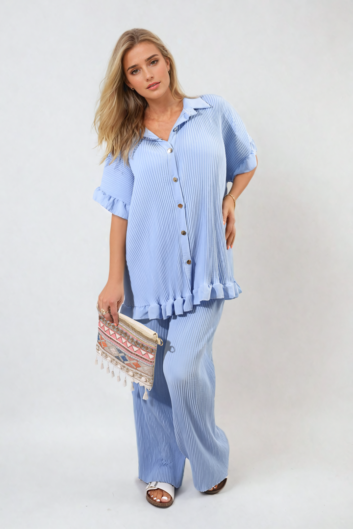 Woman wearing a Button Pleated Frill Ruffle Top and Wide Leg Trouser Co-ord Set, holding a purse, showcasing stylish women's clothing from Holiday-clothes.co.uk.