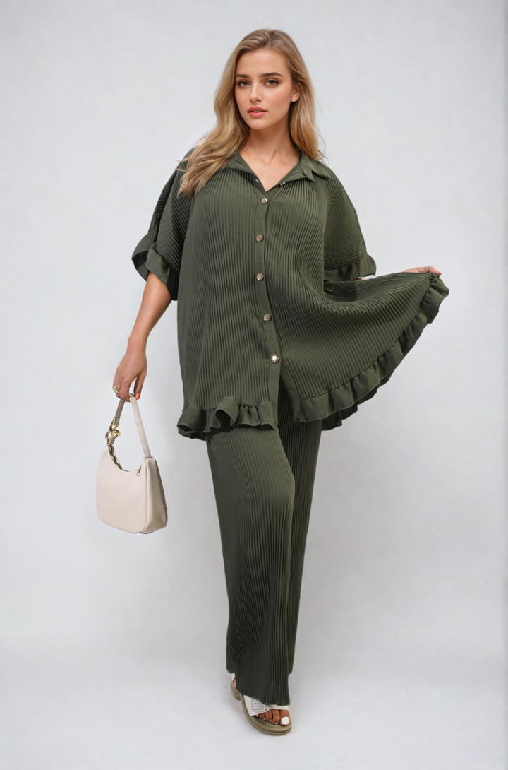 Woman wearing Emily Button Pleated Frill Ruffle Top and Wide Leg Trouser Co-ord Set, posing fashionably, highlighting elegant pleats and sophisticated design elements.