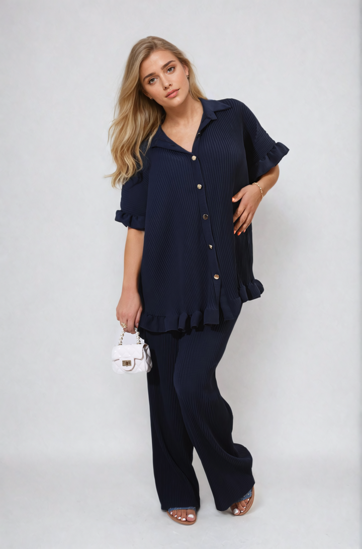 Button Pleated Frill Ruffle Top and Wide Leg Trouser Co-ord Set featuring a woman posing, highlighting elegant ruffles and wide-leg silhouette for versatile styling.