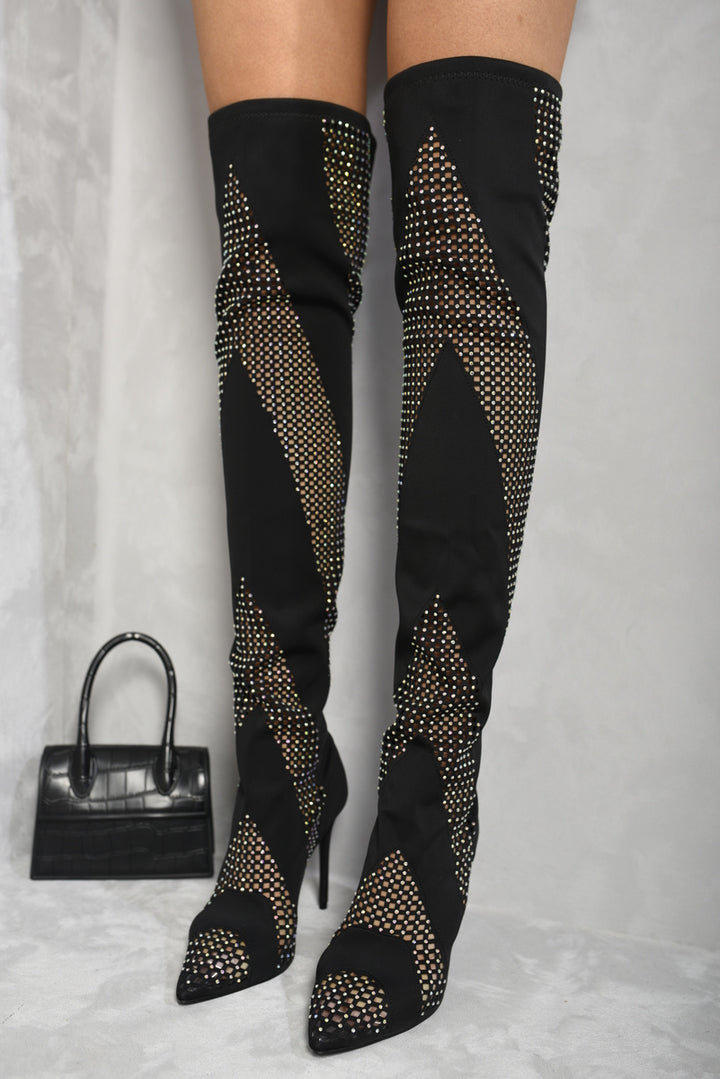 Rhinestone Mesh Knee High Boots with dazzling rhinestones and mesh design, worn with black pants. Perfect for adding glam to your outfit.