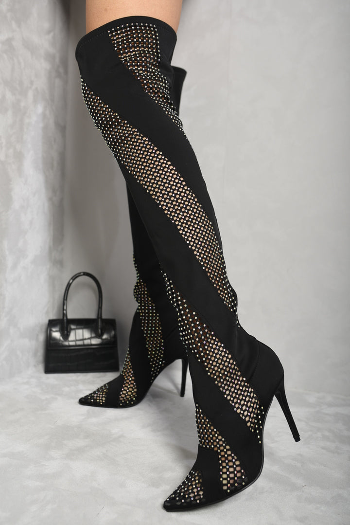 Rhinestone Mesh Knee High Boots on a woman's legs, featuring sparkling rhinestones and a mesh design, styled with high heels for a glamorous look.