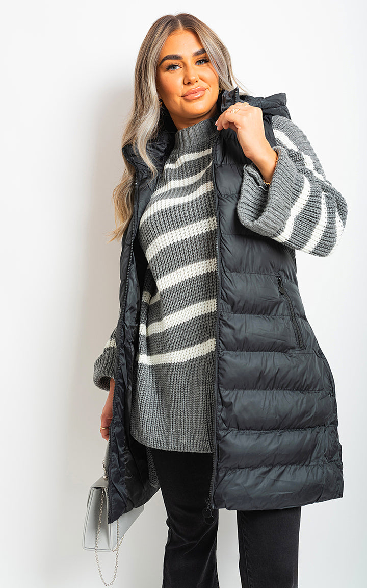 Hooded Longline Quilted Gilet showcased on a smiling woman, highlighting its stylish, warm design and versatility for casual outings or outdoor activities.