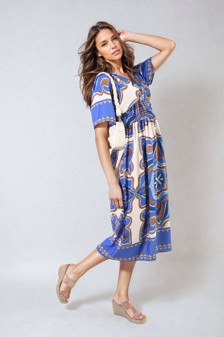 Ruched Printed V-Neck Short Sleeve Midi Dress worn by a model, showcasing its chic ruched design and printed pattern, ideal for casual occasions.