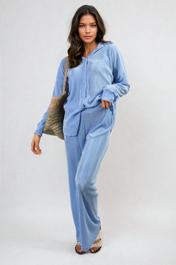 Woman wearing the Plisse Button Front Oversized Shirt and Trouser Co-ord Set, showcasing its elegant design and comfortable fit in a stylish indoor setting.