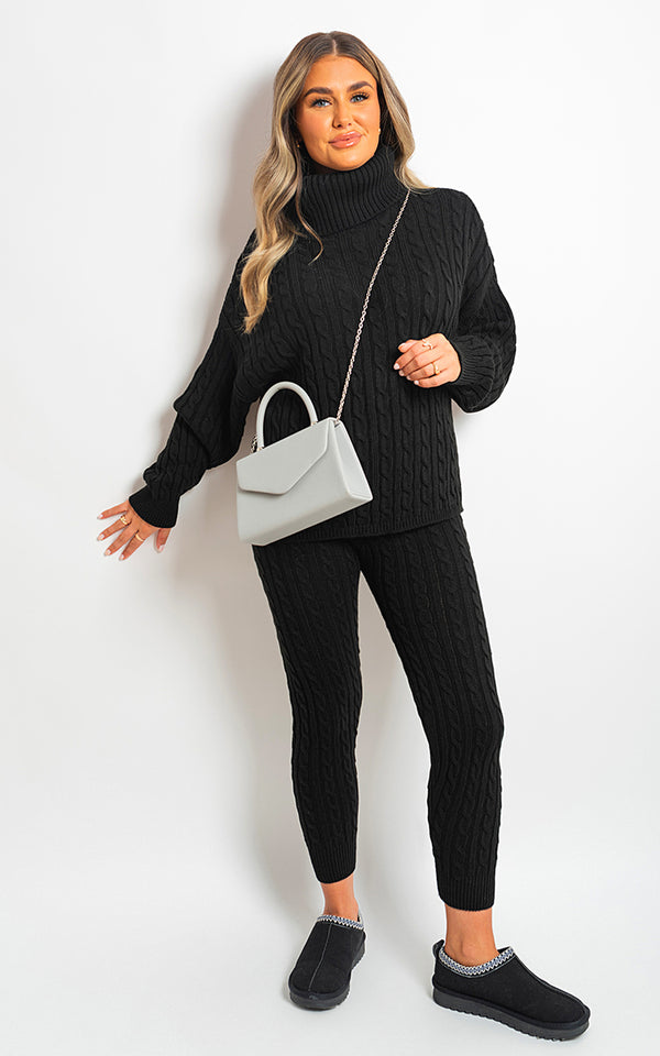 Woman wearing Turtle Neck Cable Knitted Top and Pants Co-ord Set, holding a white purse, showcasing cozy and stylish clothing from Holiday Clothes UK.