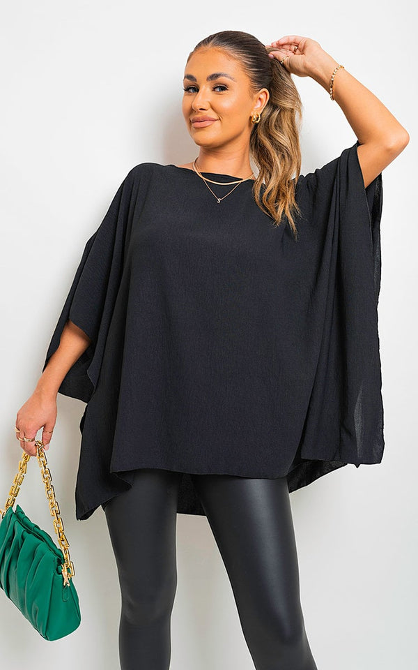 Oversized Batwing Sleeve Casual Top worn by a woman, featuring batwing sleeves and a relaxed fit, ideal for stylish and comfortable everyday wear.