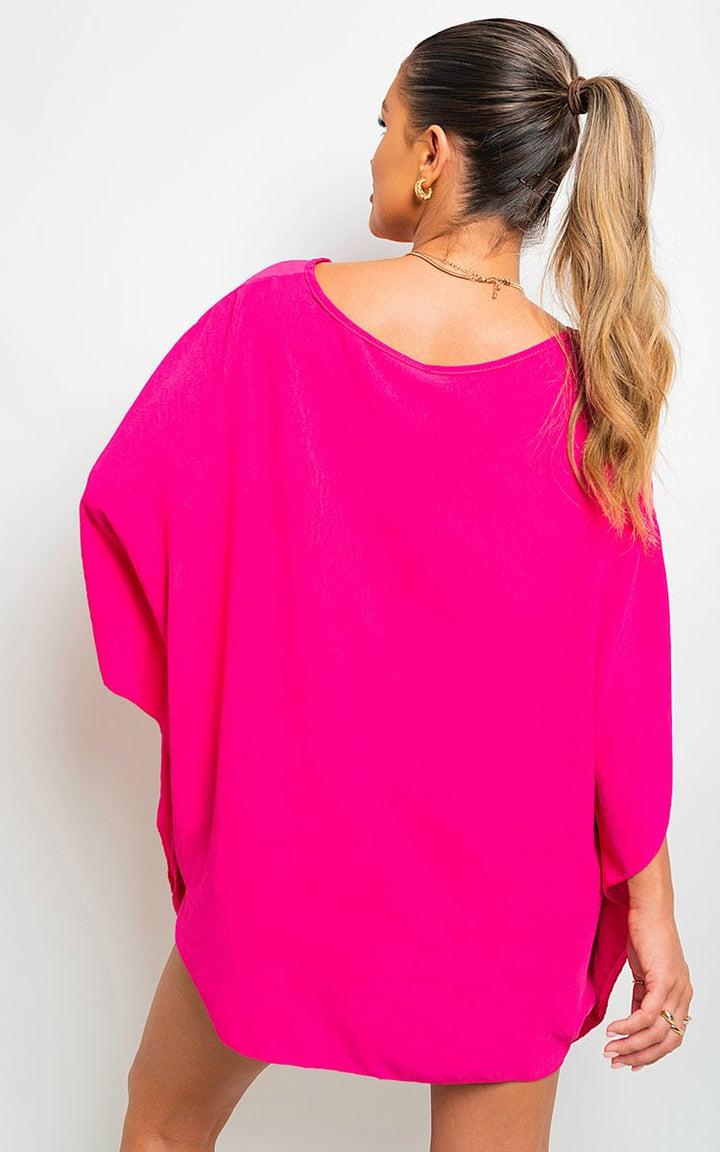 Woman wearing an Oversized Batwing Sleeve Casual Top, showcasing its relaxed fit and stylish batwing sleeves, embodying casual elegance.