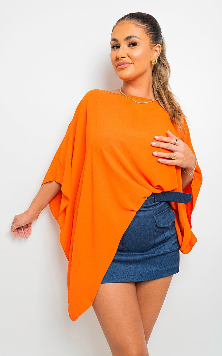 Woman wearing Fatima Oversized Batwing Sleeve Casual Top, showcasing its relaxed, fashionable design with unique batwing sleeves, ideal for stylish, everyday wear.