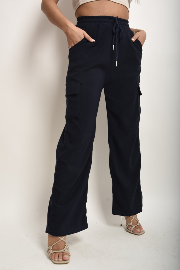 Wide Leg Drawstring Waist Flap Pocket Trouser shown with a person wearing them, highlighting the wide-leg fit and functional flap pockets.