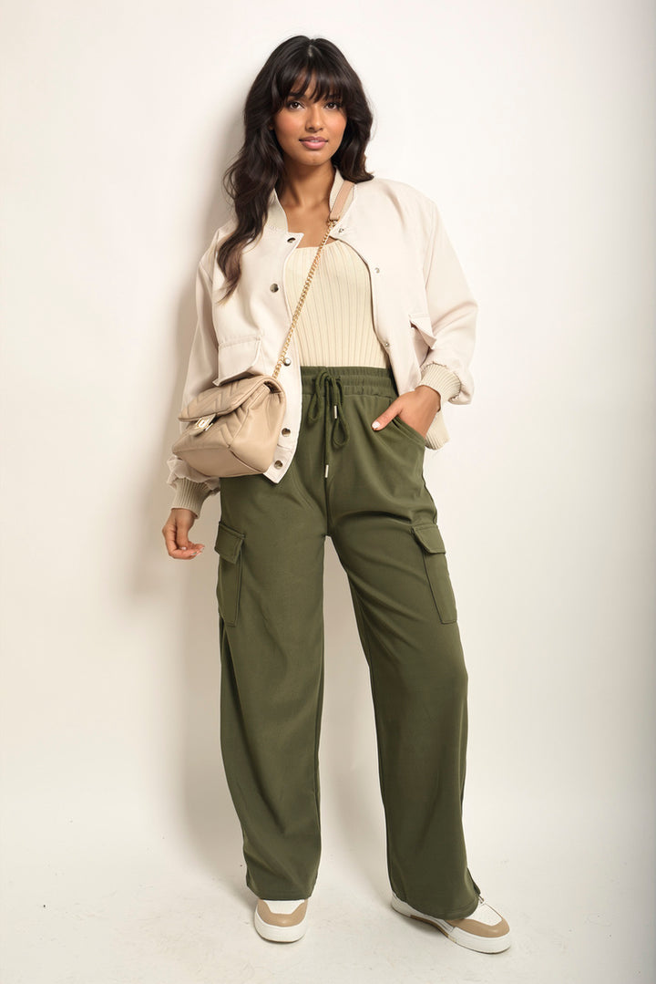 A woman models the Wide Leg Drawstring Waist Flap Pocket Trouser, showcasing its chic wide-leg design and practical flap pockets, perfect for stylish comfort.