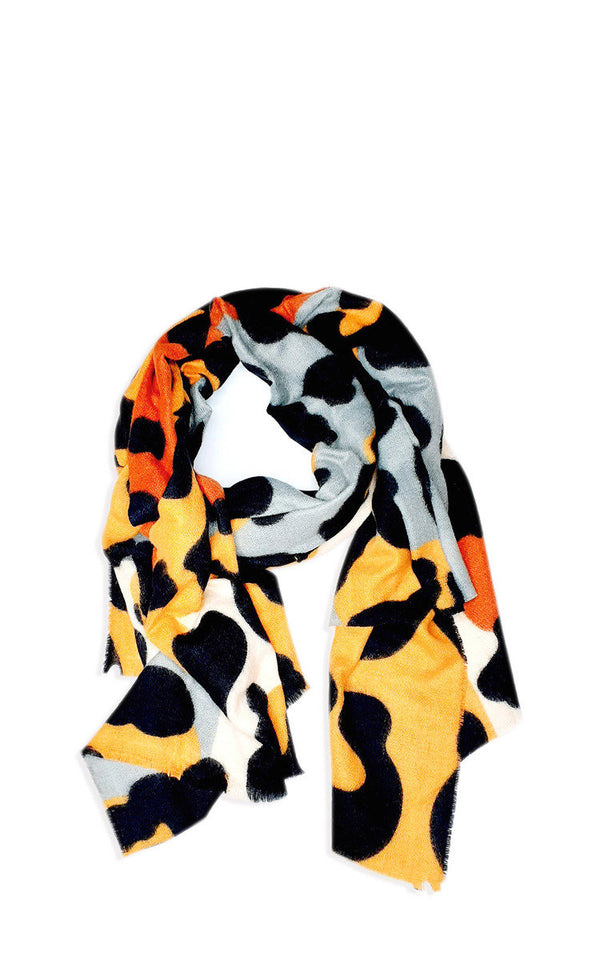 Printed Scarf with black and orange spots, featuring a super soft knitted material, ideal for pairing with padded jackets for a stylish everyday look.