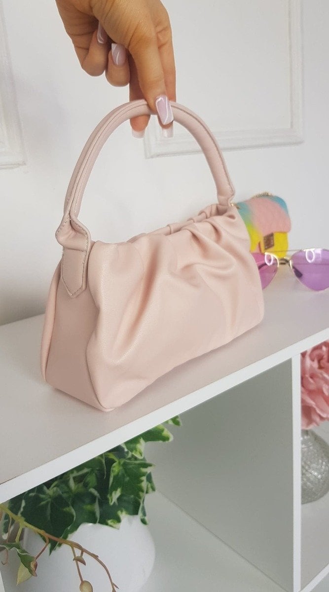 Pouch Shoulder Handbag in faux leather with stylish pouch detail, displayed on a shelf. Perfect for daily use and versatile occasions.