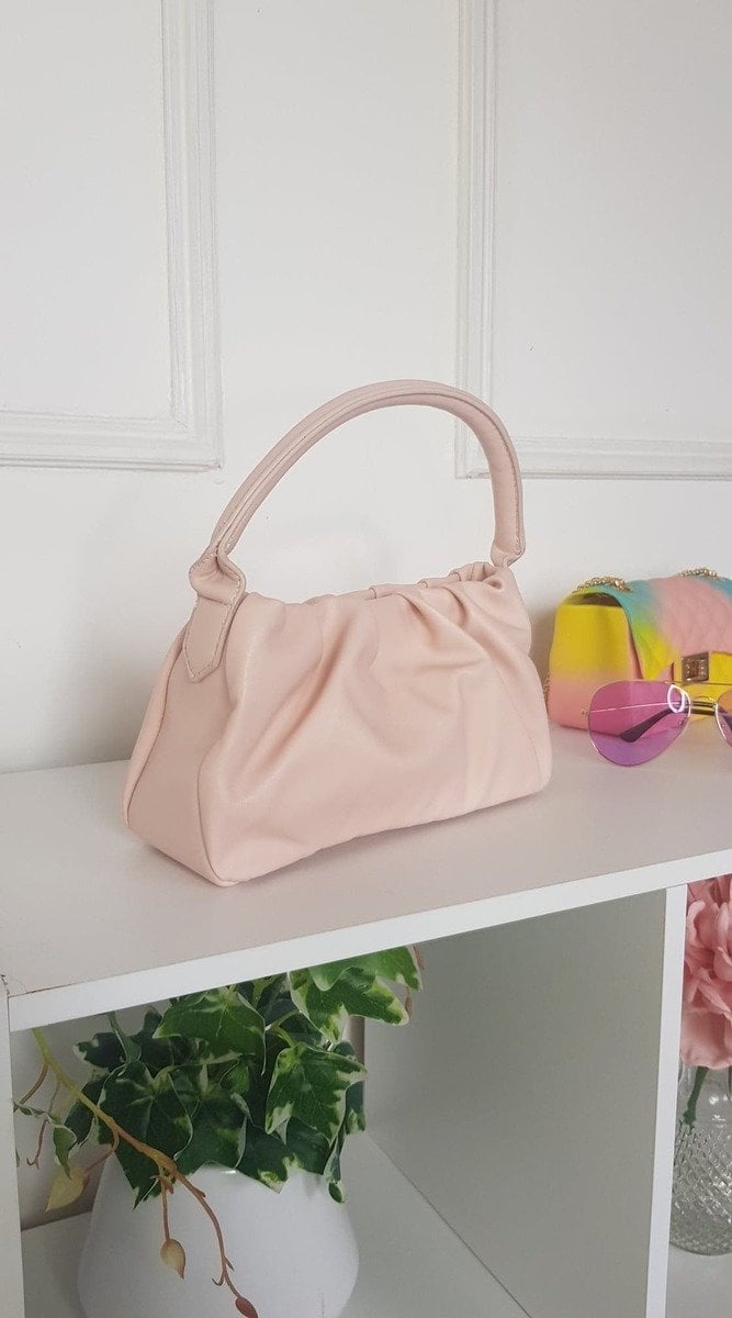 Pouch Shoulder Handbag on a white shelf, featuring stylish pouch detail, ideal for everyday activities.