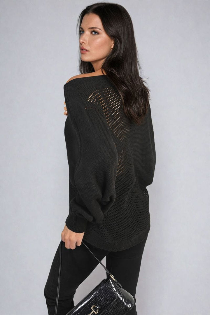 Woman wearing Crew Neck Back Patterned Knitted Jumper, holding a black purse, showcasing the jumper's cozy and chic style perfect for casual outings.