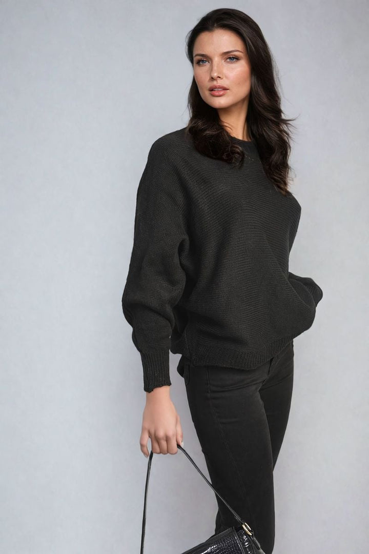 Woman holding a black purse, wearing a cozy Crew Neck Back Patterned Knitted Jumper, ideal for chic, casual comfort from Holiday Clothes UK.