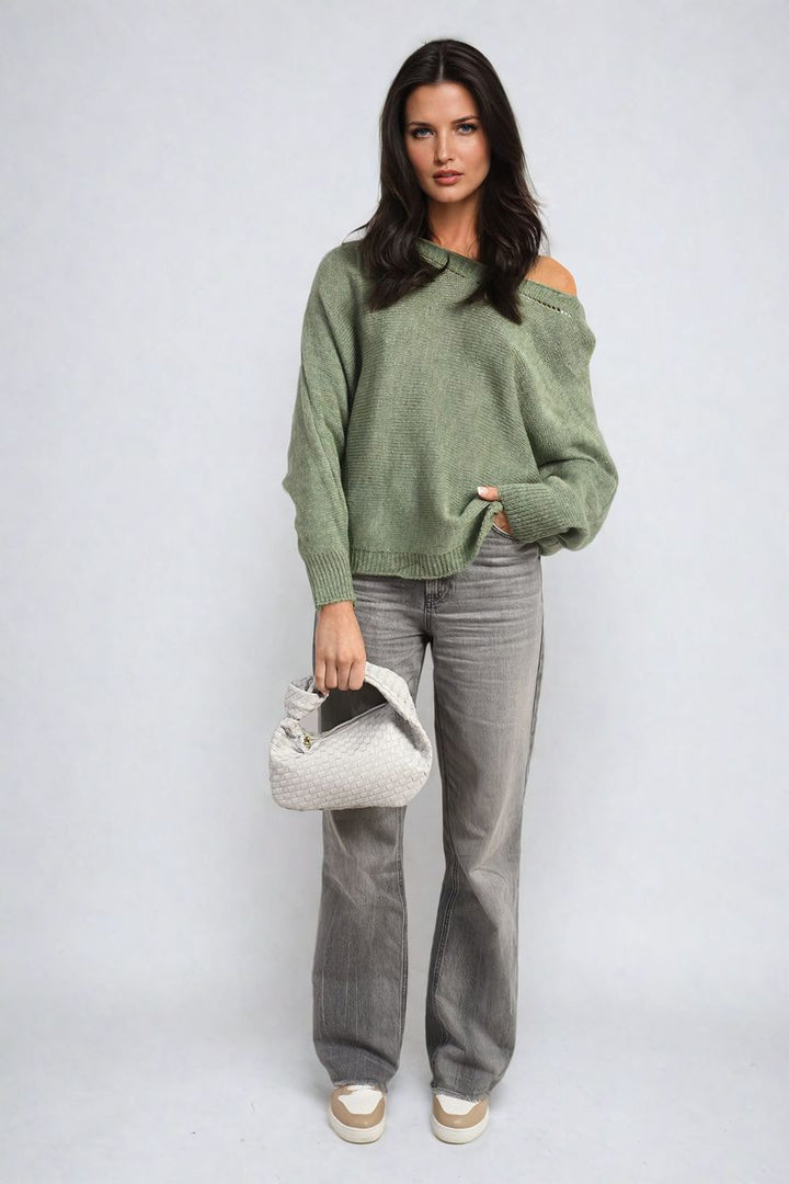 Woman holding the Crew Neck Back Patterned Knitted Jumper, showcasing its stylish design suitable for casual outings.