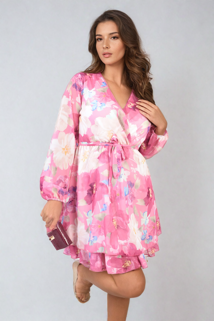 Woman in a Francesca Floral Tie Front Tiered Mini Dress, showcasing its vibrant floral print and tiered design, perfect for spring or summer occasions.