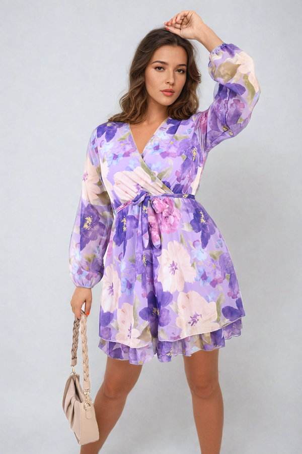 Woman wearing Francesca Floral Tie Front Tiered Mini Dress, featuring a flattering silhouette with a tie front and tiered skirt, perfect for spring occasions.