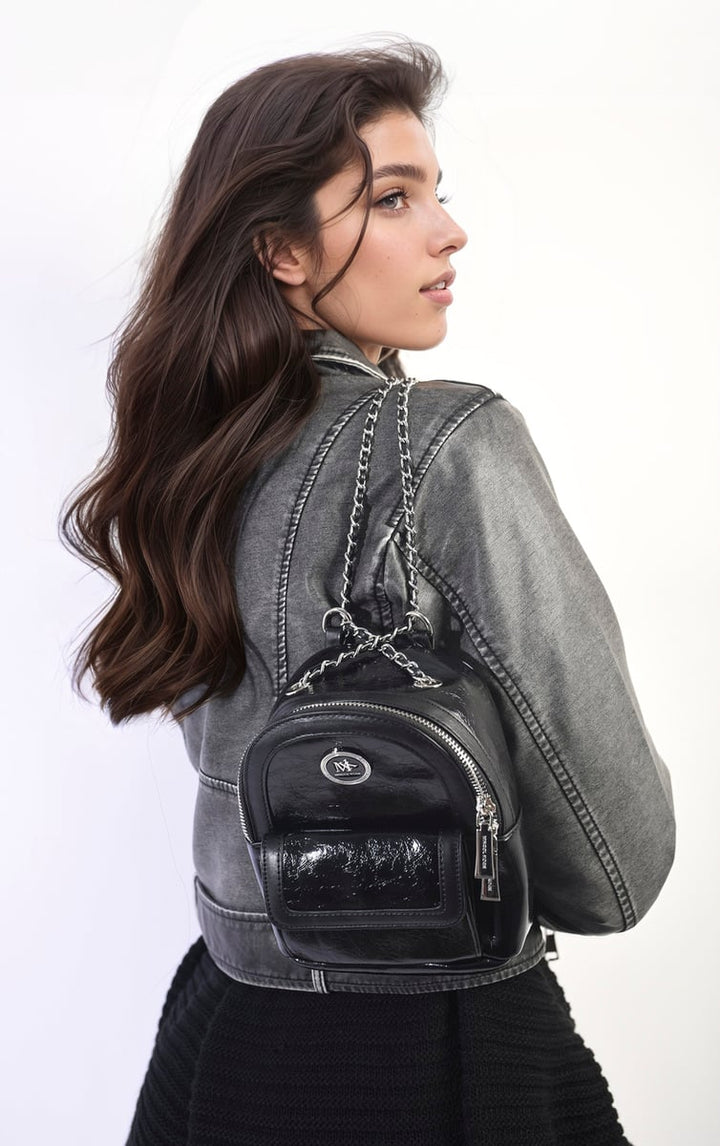 Leather Mini Backpack with Chain Strap, worn by a woman, showcasing its sleek design and chain detail, ideal for fashion-forward, on-the-go style.