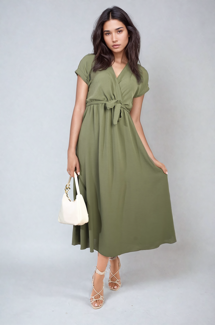 Woman in Wrap Tie Waist Short Sleeve Midi Dress with white bag, showcasing a stylish, versatile design perfect for various occasions.