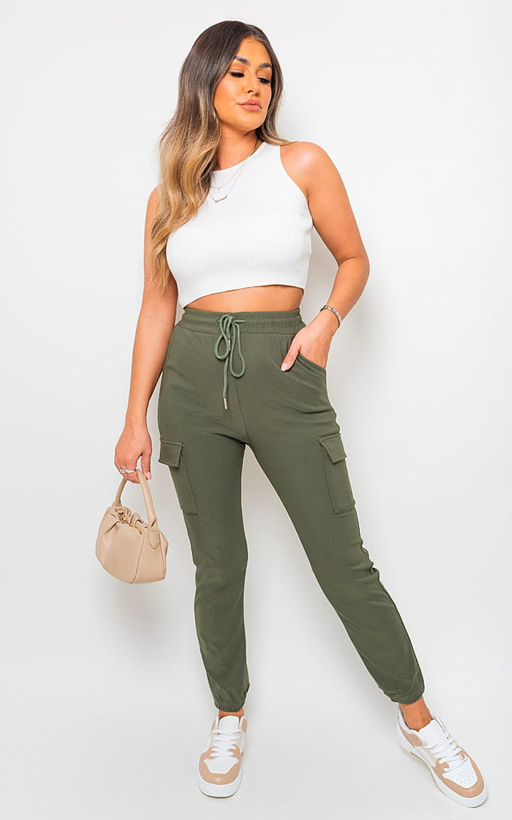 Woman modeling Fleece Lined Cargo Pocket Trouser with Drawstring, featuring utilitarian cargo pockets for style and functionality, perfect for trendy, on-the-go adventures.