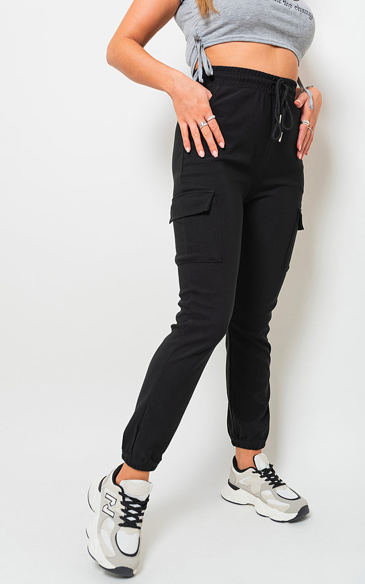 Woman wearing Holly Fleece Lined Cargo Pocket Trousers with Drawstring, showcasing utility-chic style and functionality with visible cargo pockets and a customizable fit.