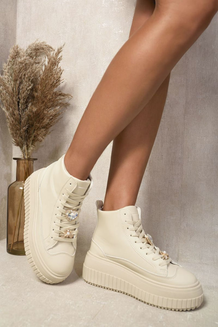 Lace Up High Top Platform Trainers with decorative details, showcasing their stylish platform sole and trendy design, perfect for everyday adventures and adding height.