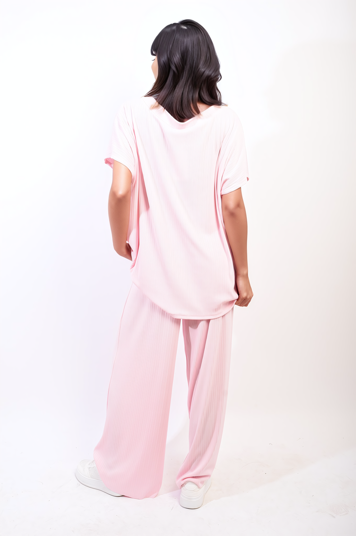 A woman models the Oversized Top and Wide Leg Trouser Co-ord Set, highlighting its relaxed fit and stylish elegance.