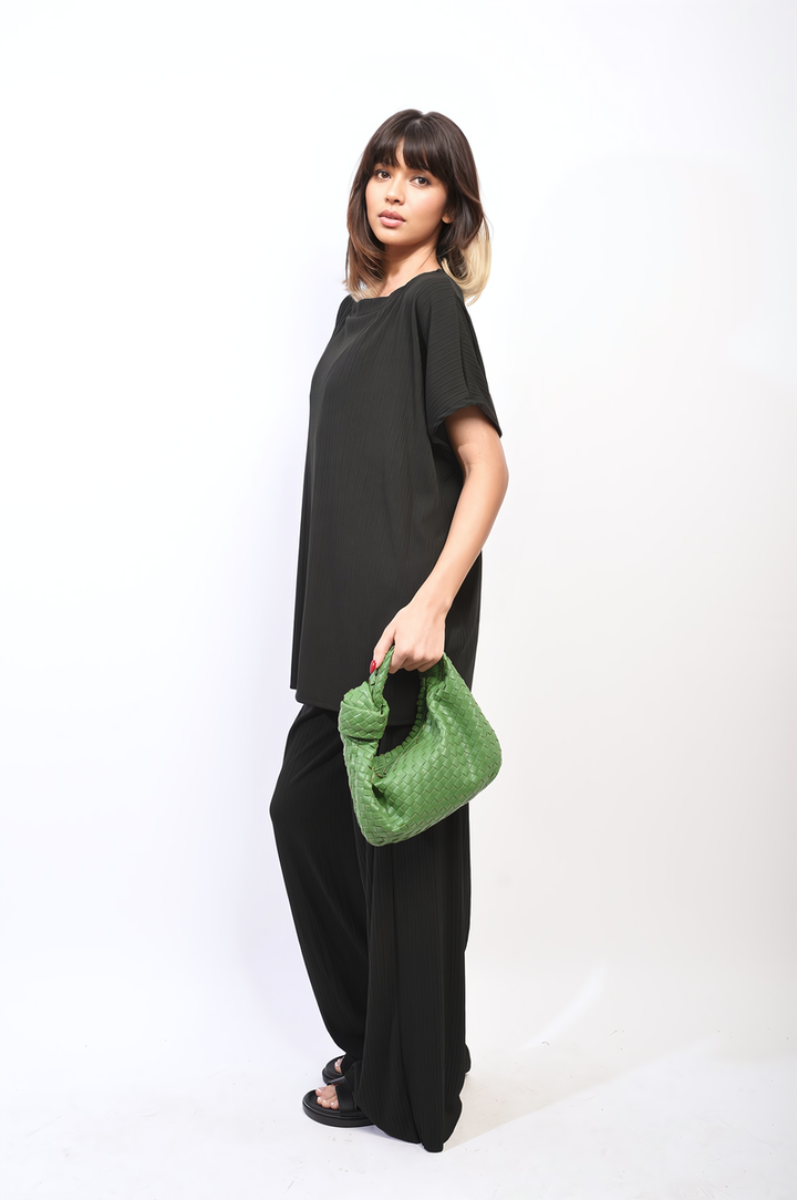 Woman in black outfit showcases Gabriella Oversized Top and Wide Leg Trouser Co-ord Set, highlighting its relaxed, chic silhouette and modern style.