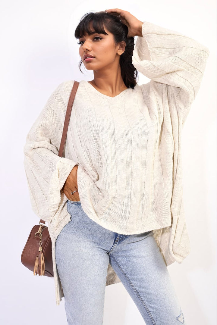 Woman in oversized knitted jumper paired with jeans, showcasing the Gabrielle Oversized Knitted Jumper's relaxed fit and stylish details, perfect for cozy elegance.