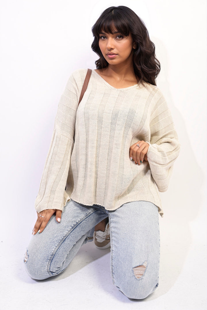 Woman wearing Gabrielle Oversized Knitted Jumper, showcasing its cozy and stylish oversized fit, ideal for pairing with jeans for casual elegance.