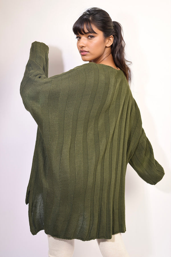 Woman wearing an Oversized Knitted Jumper, showcasing its relaxed fit and stylish knit pattern, perfect for cozy, fashionable winter wear.