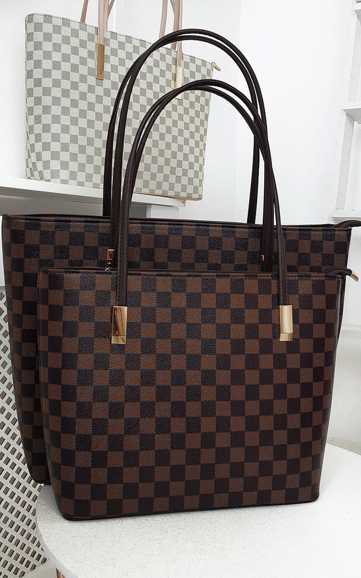 Checked Two in One Handbag featuring a brown and black checkered pattern with zip closure, displayed on a shelf.