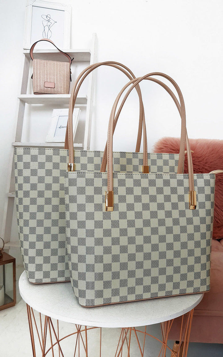 Checked Two in One Handbag on display, featuring a checkered pattern, zip closure, and detachable inner bag, ideal for transitioning from day to night.