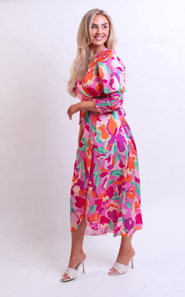 Wrap Front Printed Midi Dress: Woman models a stylish, colorful wrap front midi dress with a flattering silhouette, perfect for special occasions or nights out.