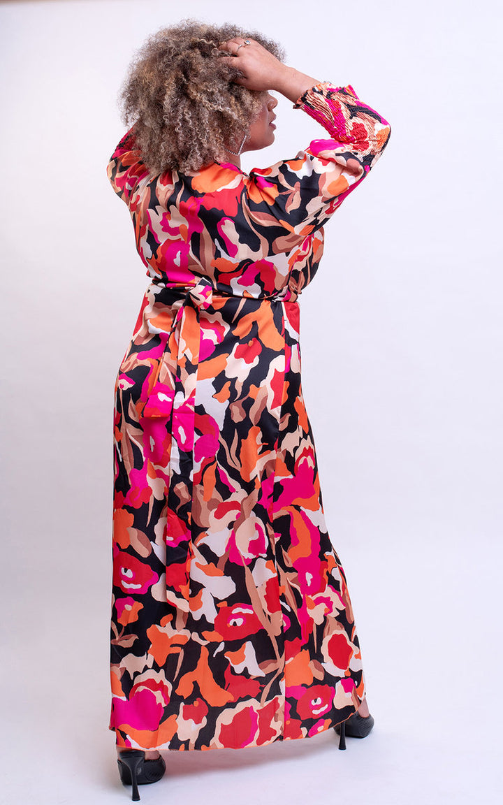 Woman in Wrap Front Printed Midi Dress with colorful pattern, showcasing a trendy and figure-flattering design. Perfect for special occasions or nights out.