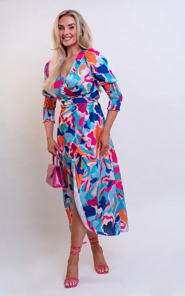 Wrap Front Printed Midi Dress featuring a vibrant pattern, worn by a smiling woman, highlighting its elegant wrap design and flattering silhouette for stylish occasions.