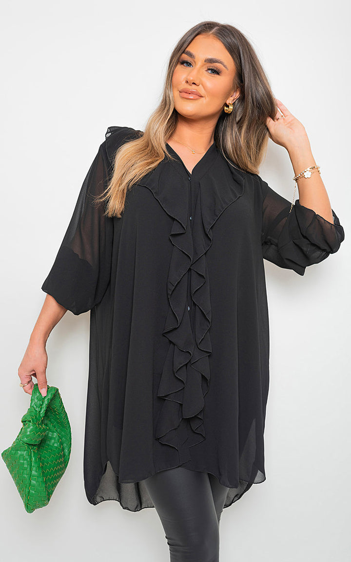 Woman wearing Oversized Ruffle Long Sleeve Tops with ruffle sleeve details, styled for elegance and comfort, ideal for versatile occasions.