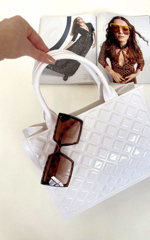 Faux Leather Quilted Handbag held by a hand, paired with brown sunglasses, showcasing a chic, versatile fashion accessory perfect for day-to-night elegance.